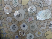 Detail, showing the backstamps on the mural created by contemporary ceramic artist Emma Biggs.